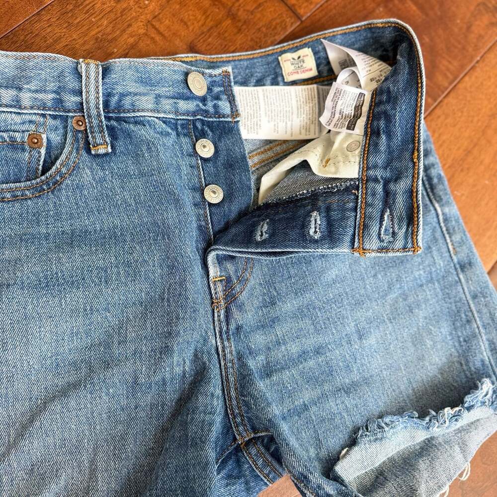 Levi Strauss & Co. denim cutoff shorts, size W26, with a distressed/frayed raw h